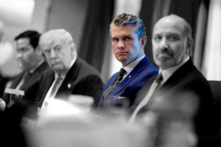 Pete Hegseth sitting at a meeting.