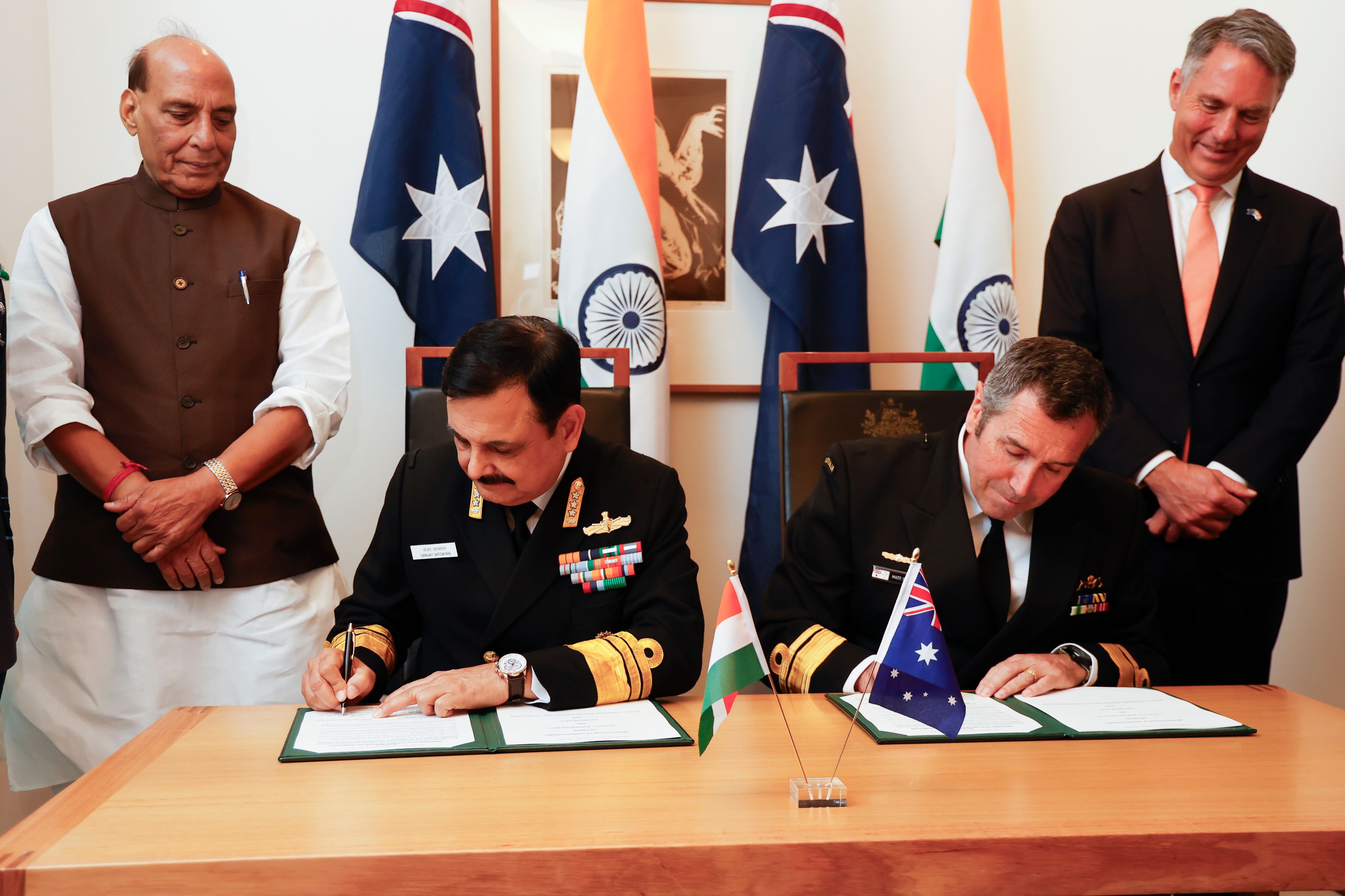 ndian Defence Minister, Shri Rajnath Singh (L) and Deputy Prime Minister and Minister for Defence, Richard Marles (R) witness Vice Chief of the Naval Staff of India, Sanjay Vatsayan (2nd-L) and Australia's Deputy Chief of Navy Matt Buckley (2nd-R) signing defence cooperation documents to Australia for his first official visit on October 09, 2025 in Canberra, Australia