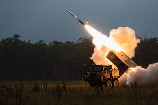 An army vehicle firing a rocket during a military exercise