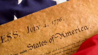 declaration-of-independence-with-flag-header-GettyImages-91832605.png