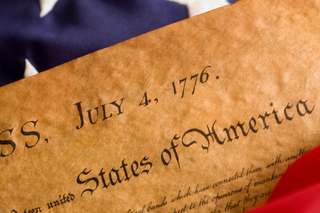 declaration-of-independence-with-flag-header-GettyImages-91832605.png