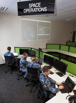 Personnel take up position in the Space Operations Section of the No. 1 Remote Sensor Unit at RAAF Base Edinburgh