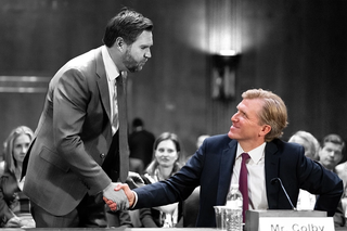Elbridge Colby shakes hands with Vice President JD Vance, while at a hearing.