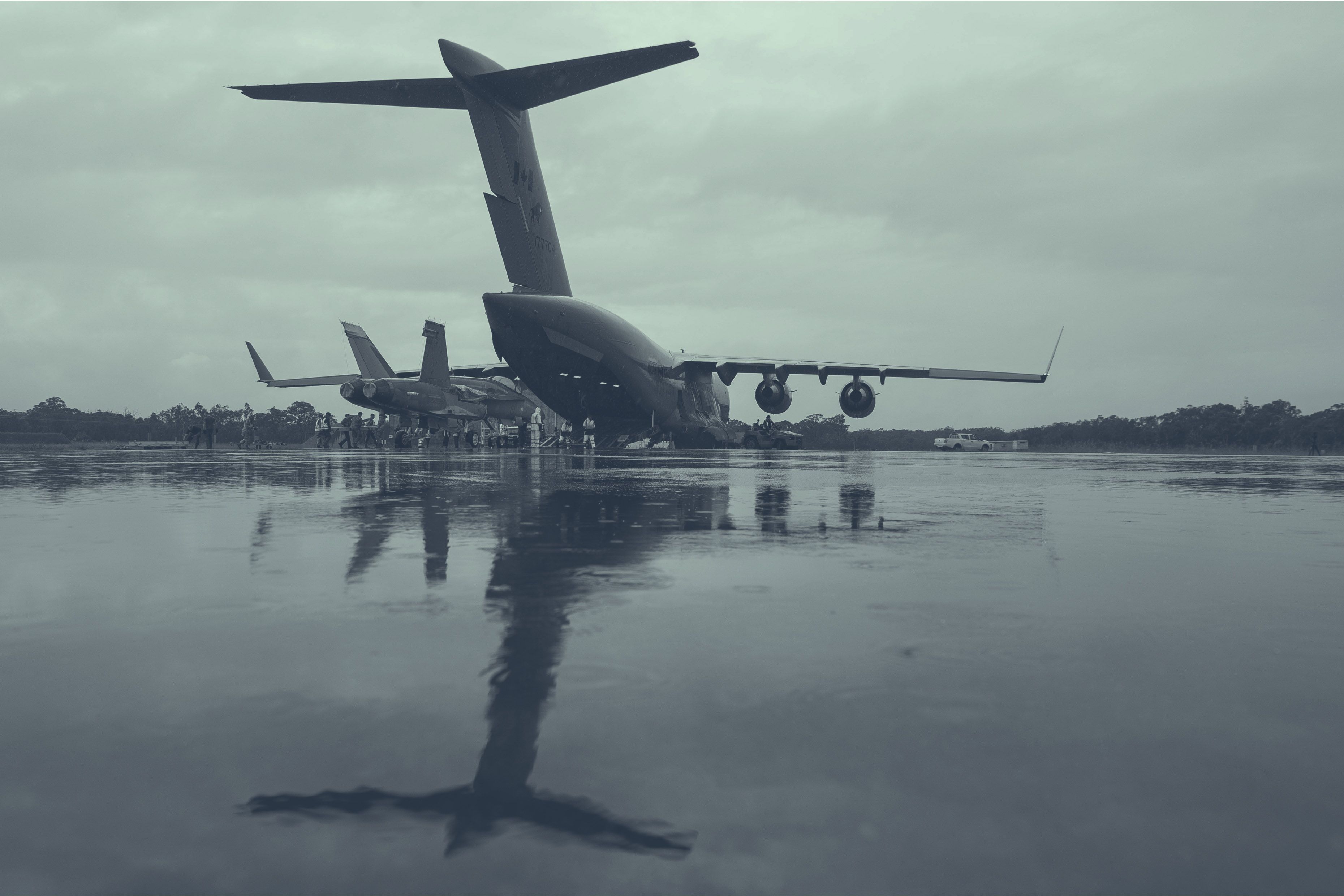 Members of the Royal Canadian Air Force (RCAF) and the Royal Australian Air Force (RAAF) load a F/A-18 aircraft on to an RCAF CC-177 Globemaster for transport back to Canada, as part of the Interim Fighter Capability Project at RAAF Base Williamtown, Australia, February 2020.