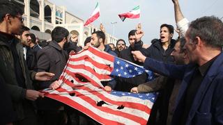 Iranians tear up a US flag during a demonstration in Tehran on 3 January 2020 following the killing of Iranian Revolutionary Guards Major General Qasem Soleimani in a US strike on his convoy at Baghdad international airport