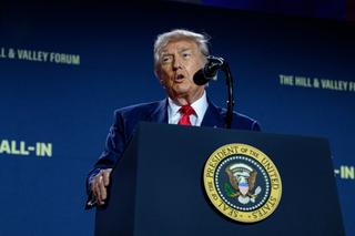 President Trump standing making a speech at a podium.