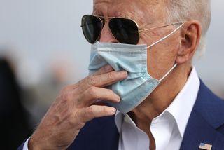 Wearing a face mask to reduce the risk posed by the coronavirus, Democratic presidential nominee Joe Biden speaks with reporters in Delaware, October 2020