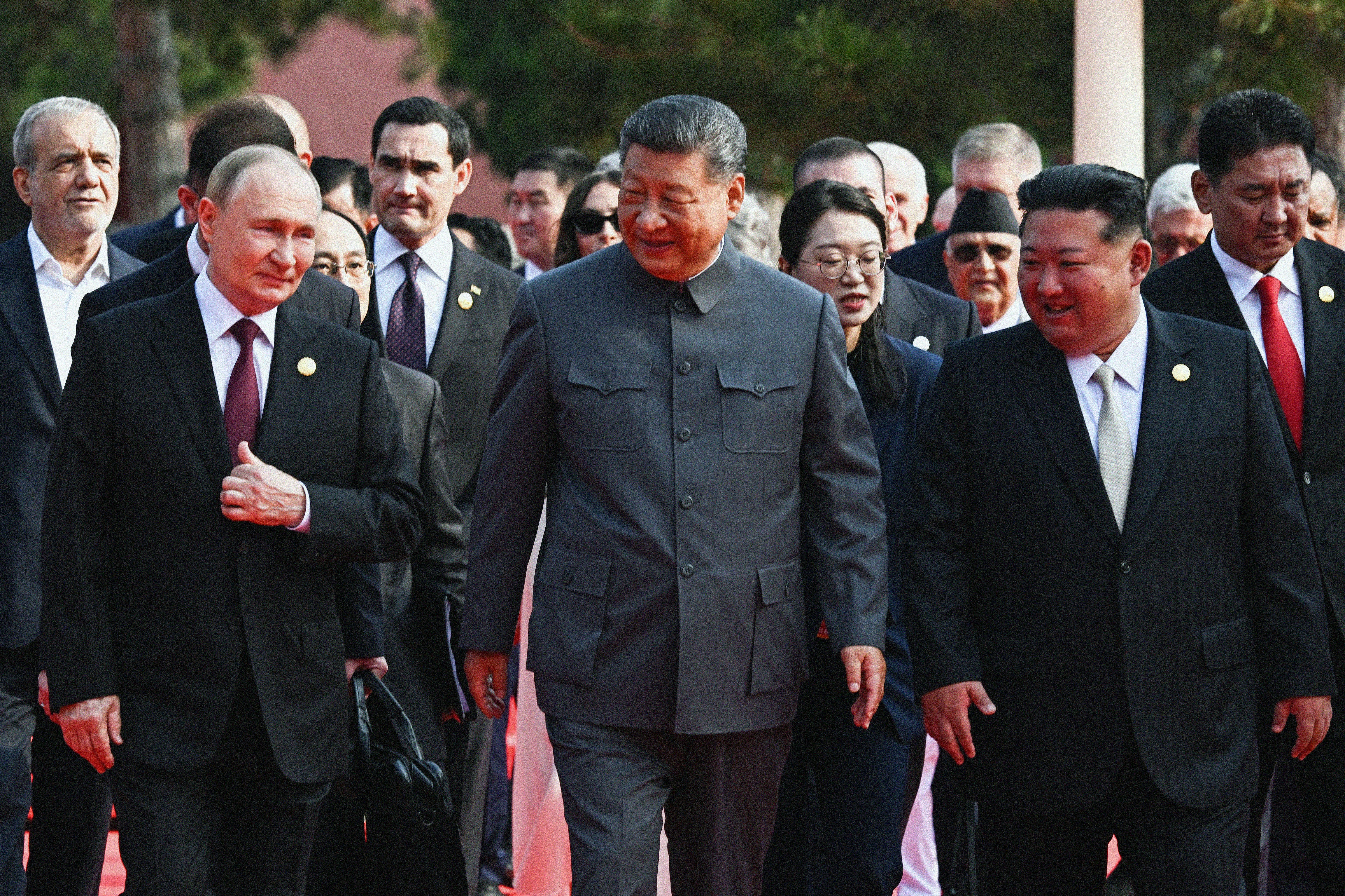  In this pool photograph distributed by the Russian state agency Sputnik, (L-R) Russia's President Vladimir Putin walks with China's President Xi Jinping and North Korea's leader Kim Jong Un before a military parade marking the 80th anniversary of victory over Japan and the end of World War II, in Beijing's Tiananmen Square on September 3, 2025.