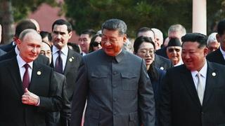 In this pool photograph distributed by the Russian state agency Sputnik, (L-R) Russia's President Vladimir Putin walks with China's President Xi Jinping and North Korea's leader Kim Jong Un before a military parade marking the 80th anniversary of victory over Japan and the end of World War II, in Beijing's Tiananmen Square on September 3, 2025.