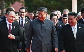 In this pool photograph distributed by the Russian state agency Sputnik, (L-R) Russia's President Vladimir Putin walks with China's President Xi Jinping and North Korea's leader Kim Jong Un before a military parade marking the 80th anniversary of victory over Japan and the end of World War II, in Beijing's Tiananmen Square on September 3, 2025.