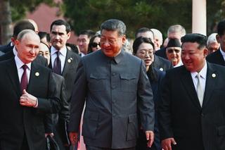In this pool photograph distributed by the Russian state agency Sputnik, (L-R) Russia's President Vladimir Putin walks with China's President Xi Jinping and North Korea's leader Kim Jong Un before a military parade marking the 80th anniversary of victory over Japan and the end of World War II, in Beijing's Tiananmen Square on September 3, 2025.