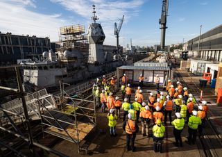 Navy personnel and contractors during a briefing at the Captain Cook Graving Dock on Garden Island, New South Wales