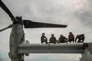 US Marines conduct maintenance on an MV-22 Osprey