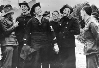 US sailors newly landed in Australia trade hats with Australian soldiers in 1945