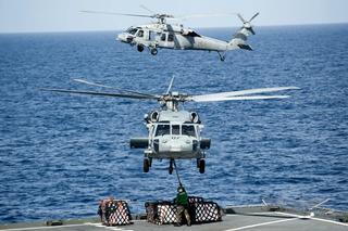 MH-60S Sea Hawk helicopters lift supplies from USNS Amelia Earhart T-AKE 6 before delivering them to the aircraft carrier USS George Washington CVN 73, Pacific Ocean, 2012.