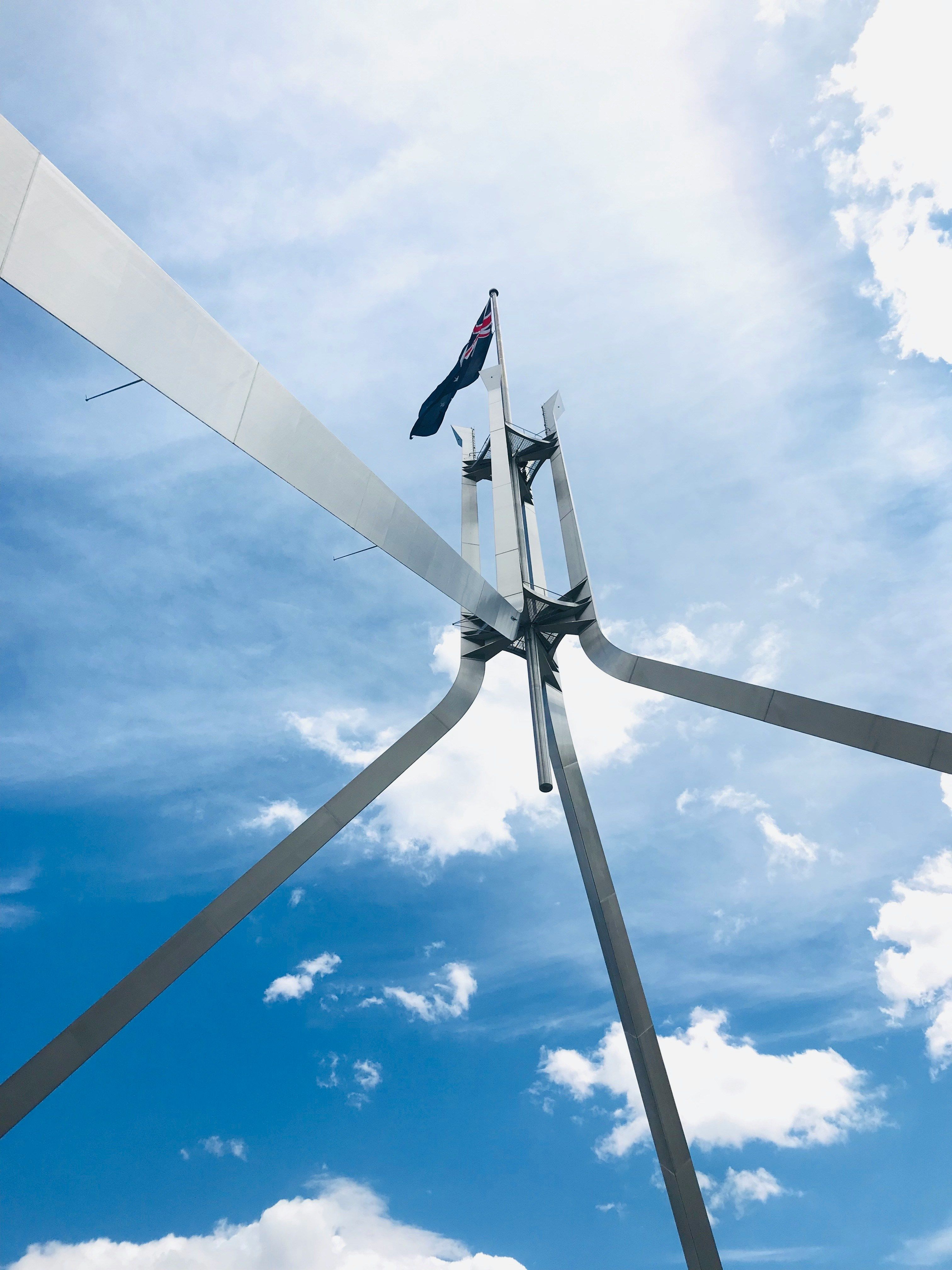 Bottom-up view of Australian flag atop Parliament House