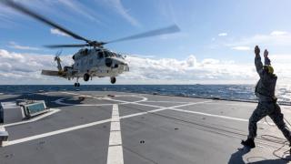 A Japan Maritime Self-Defense Force Seahawk helicopter from JS Inazuma during flying operations as part of Exercise Nichi Gou Trident 2021