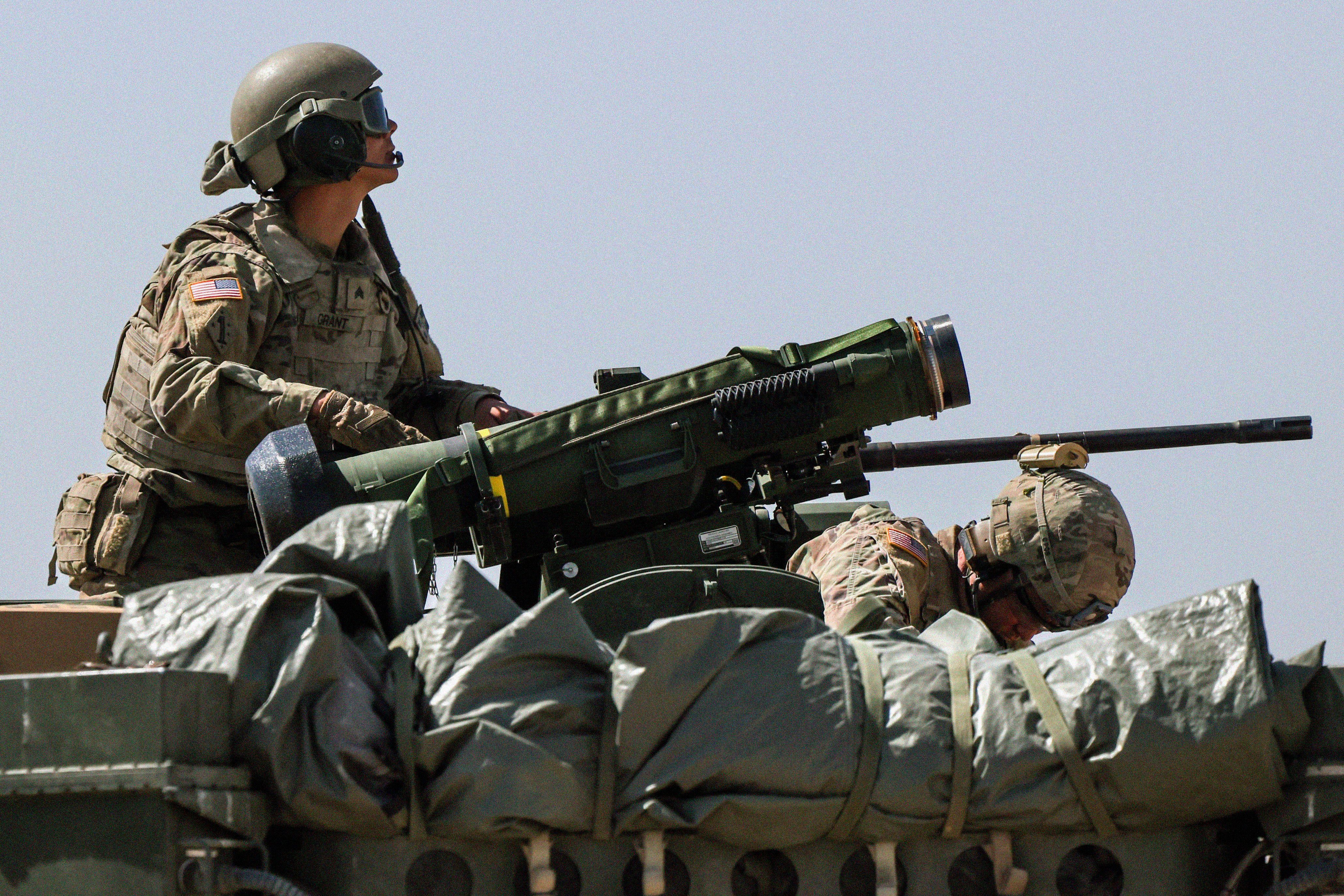 A person operating a large weapon during a training exercise.