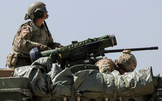 A person operating a large weapon during a training exercise.