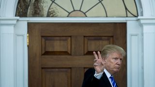 President-elect Donald Trump gives the peace sign after his meeting with Betsy DeVos at Trump International Golf Club, November 19, 2016 in Bedminster Township, New Jersey.