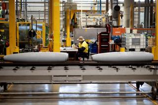 Thales Australia employee examining munitions, partway through the manufacturing process at the Benalla production line.