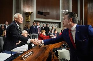 US President-elect Donald Trump's nominee for Secretary of Defense Pete Hegseth greets Senate Armed Services Committee Chairman Senator Roger Wicker during his confirmation hearing on Capitol Hill in January 2025
