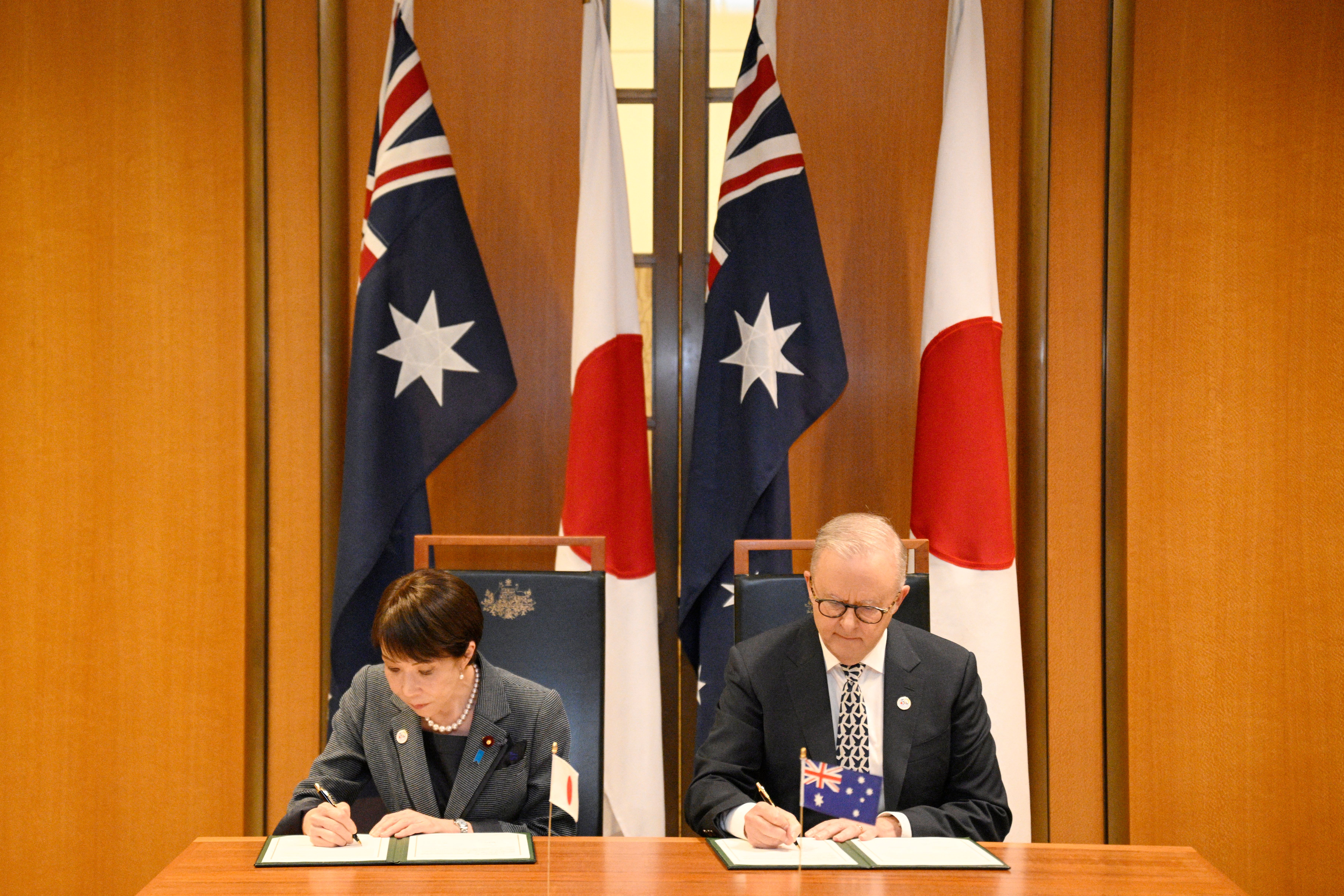 Japan's Prime Minister Sanae Takaichi (L) and Australia's Prime Minister Anthony Albanese take part in a signing ceremony for a joint declaration of economic security cooperation at Parliament House in Canberra on May 4, 2026.