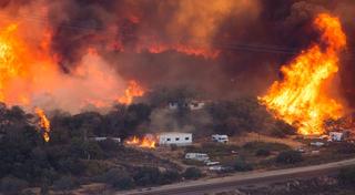 Flames sweep through a rural community near Wrightwood, California, August 2016