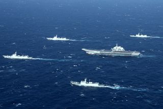 This aerial photo taken on January 2, 2017 shows a Chinese navy formation, including the aircraft carrier Liaoning (C), during military drills in the South China Sea.