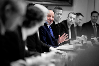 Howard Lutnick at a meeting table discussing with the President's cabinet.