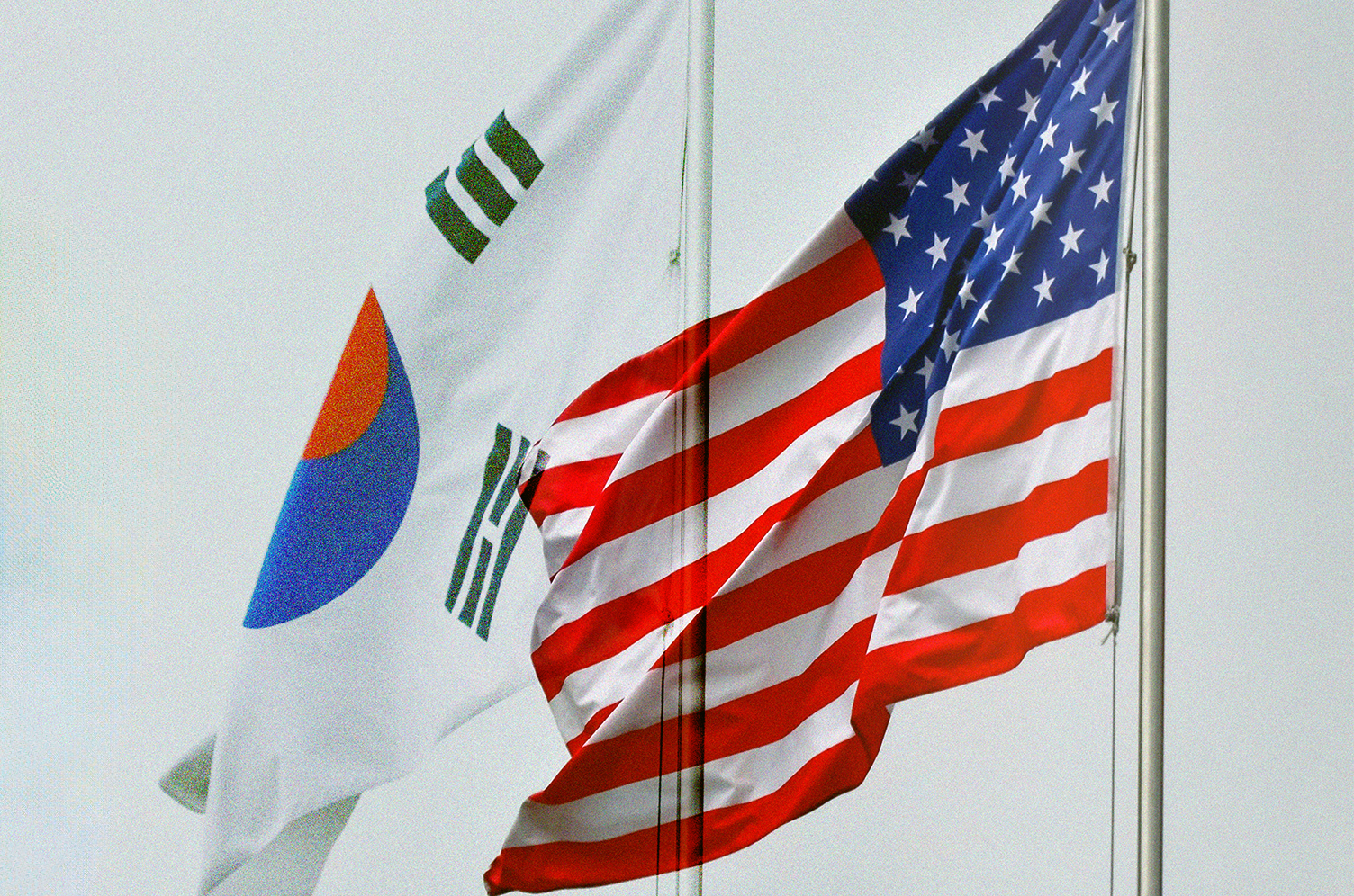South Korean and United States flags waving in the wind.