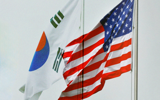 South Korean and United States flags waving in the wind.