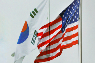 South Korean and United States flags waving in the wind.