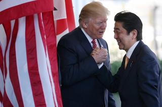 US President Donald Trump (L) greets Japan's Prime Minister Shinzo Abe as he arrives at the White House on February 10, 2017 in Washington, DC.