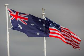 Australian and US flags blowing in the wind