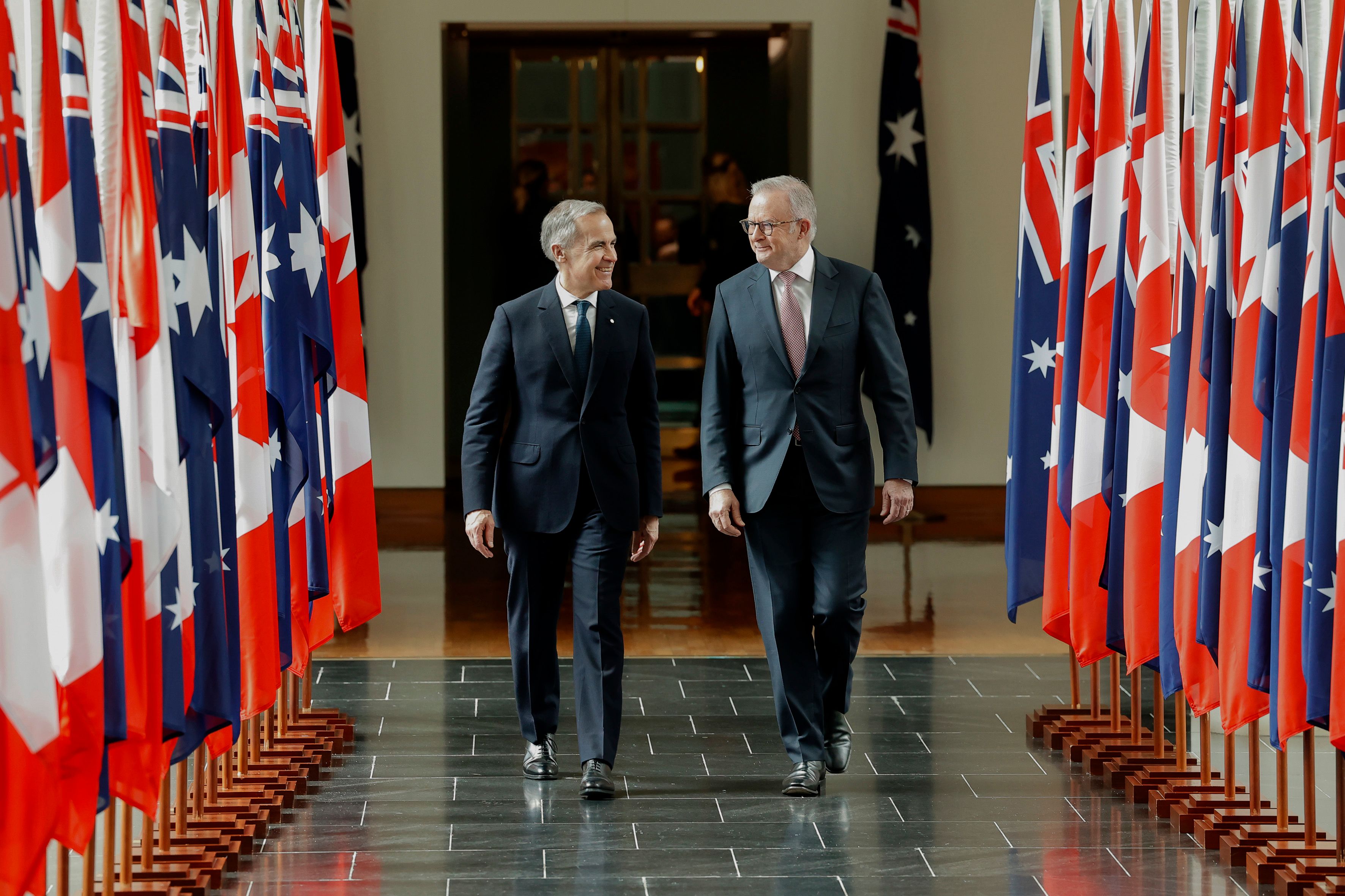 Canadian Prime Minister Mark Carney walks with Australian Prime Minister Anthony Albanese following his address to members and senators of parliament at Australian Parliament House on March 05, 2026 in Canberra, Australia.