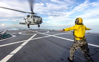 Cover photo: HMAS Warramunga’s embarked MH-60R helicopter ‘Sabertooth’ conducts free-deck landings during AUSINDEX 21.