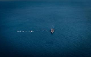  Air Task Group aircraft fly in formation over the USS Ronald Regan in the Timor Sea while participating in Exercise Talisman Sabre 23