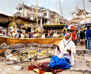 A woman praying at the site of the Bali bombings in Indonesia, 2002