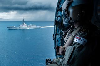 Australian seaman looking at HMAS Brisbane