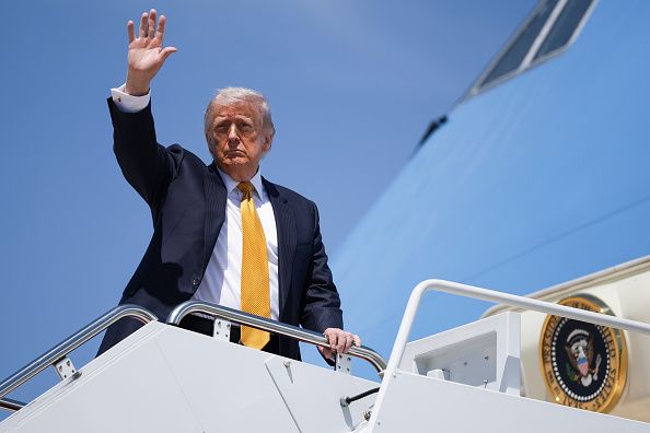 U.S. President Donald Trump waves as he boards Air Force One on May 12, 2026 at Joint Base Andrews, Maryland. Trump is traveling to China where he is scheduled to meet with Chinese President Xi Jinping for expected talks on the Iran conflict, trade imbalances, regional security, and economic cooperation between the two countries. 