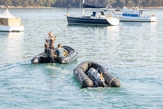 Underwater Operators from the United States Navy prepare to launch an underwater autonomous vehicle during Exercise AUKUS at Pittwater, New South Wales. Source: Department of Defence.