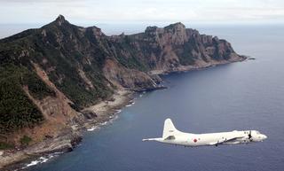 A Japanese Maritime Self-Defense Force P-3C patrol plane flying over the disputed islets known as the Senkaku islands in Japan and Diaoyu islands in China, in the East China Sea, October 2011.