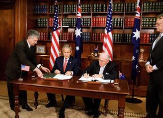 US President George W. Bush and Australian Prime Minister John Howard sign the Defence Trade Cooperation Treaty in the Cabinet Room of the Commonwealth Parliament Office in Sydney, September 2007.