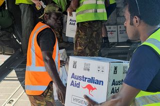 Ground crew and members of the Royal Australian Air Force load boxes of aid onto a C-130 Hercules aircraft in Port Moresby before heading to the site of a landslide in Papua New Guinea, May 2024.