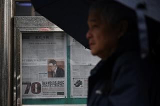 A man walks past a newspaper displayed in Seoul on 5 April 2025, after the Constitutional Court upheld the impeachment of South Korean President Yoon Suk Yeol.