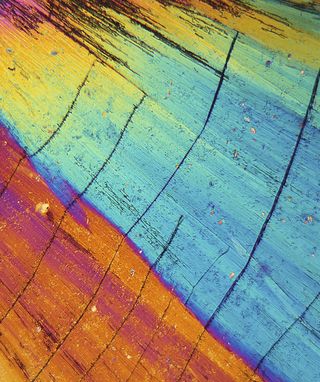 Thulium is precipitated from a solution on a microscope slide and photographed in polarised light