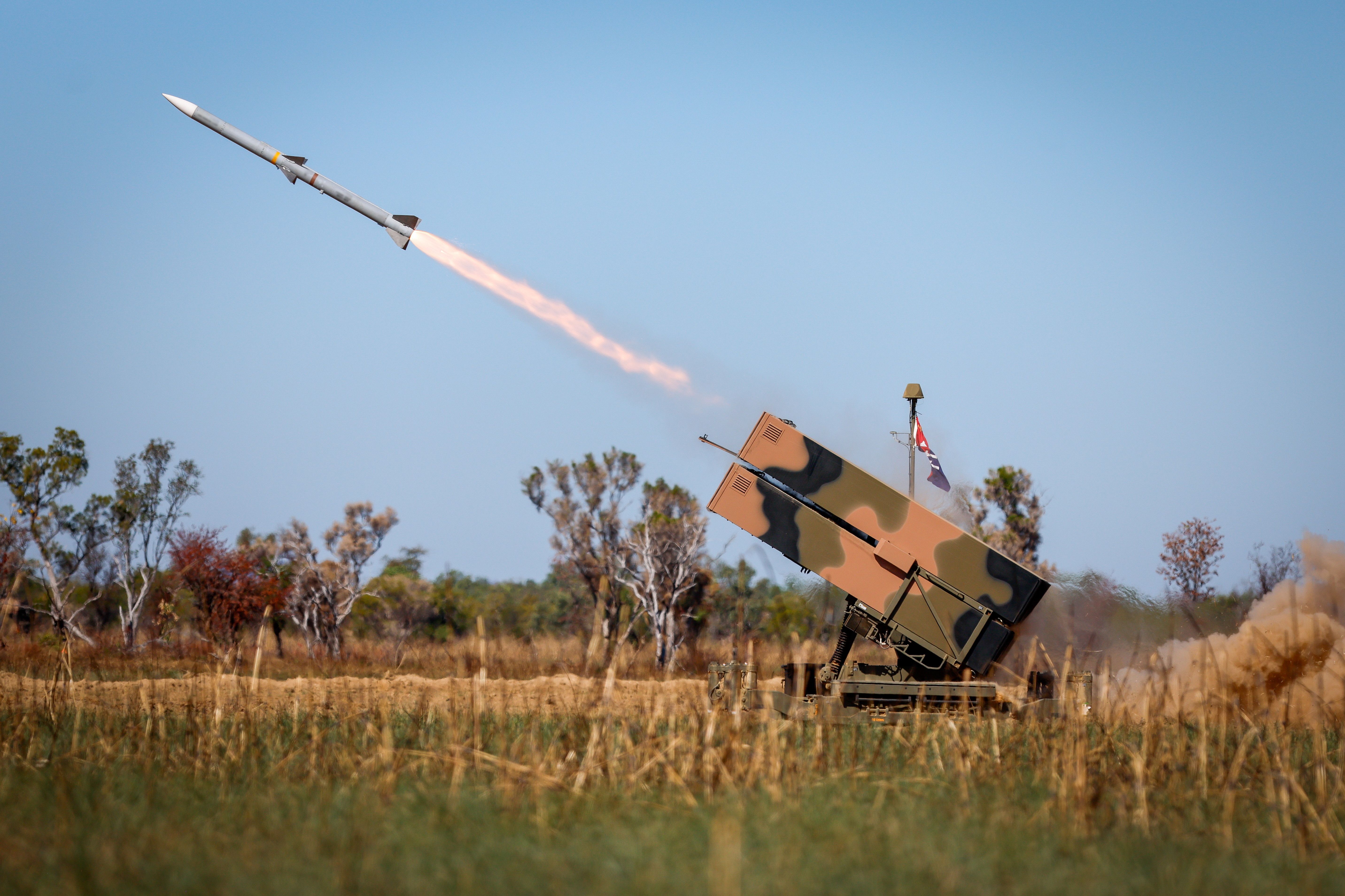 An Australian Army National Advanced Surface to Air Missile System (NASAMS) from the 16th Regiment, Royal Australian Artillery firing an AIM-120 missile during Exercise Talisman Sabre 2025 at Bradfield Training Area. Image has been digitally altered for security purposes.