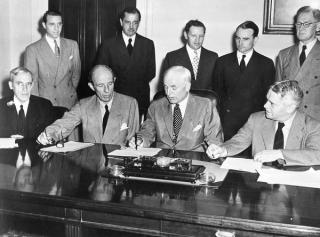 Signing the Lend-Lease agreement in Washington, 1942: US Secretary of State Cordell Hull (second from right), and representatives of Great Britain, Australia and New Zealand, including Owen Dixon, Australia’s Minister to the United States (far right, seated)