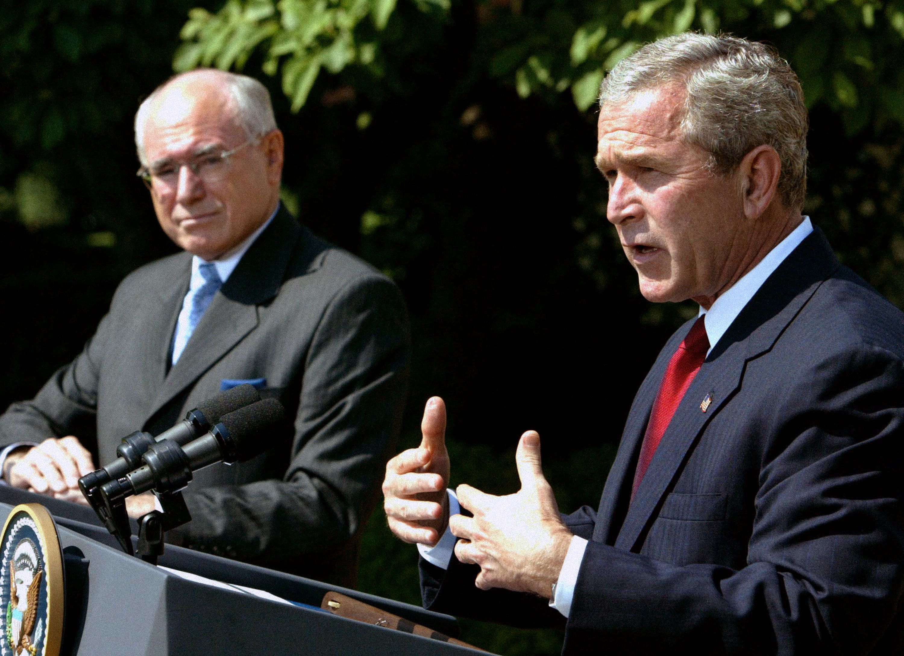 US President George W. Bush (R) and Australian Prime Minister John Howard speak in the Rose Garden at the White House June 3, 2004 in Washington, DC. The two leaders met in the Oval Office and discussed Australian and US relations as well as the war in Iraq.